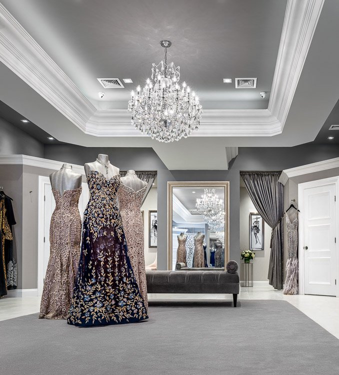 Emily's boutique with three mannequins wearing ornate dresses