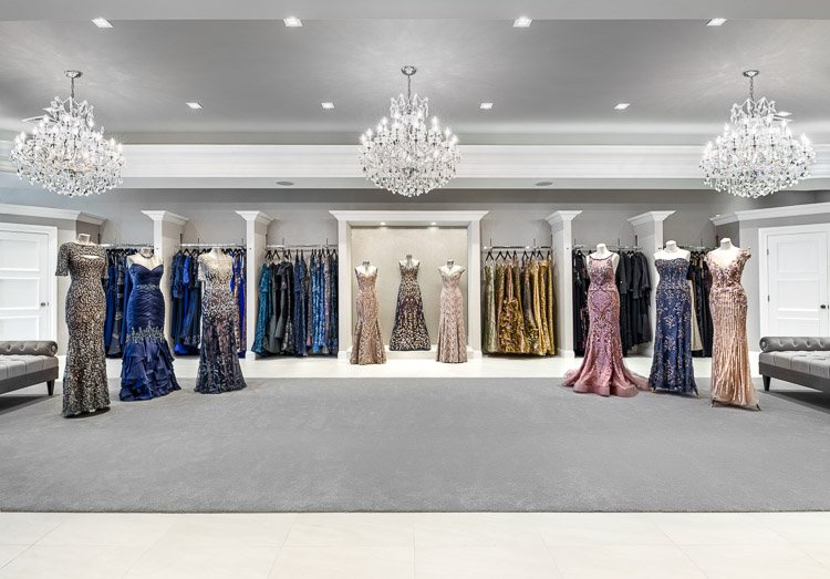 Emily's Boutique with nine mannequins, racks of dresses and three chandeliers
