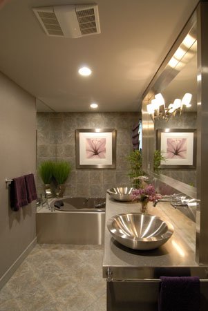 Grey bathroom with a tub and a double vanity with mirror
