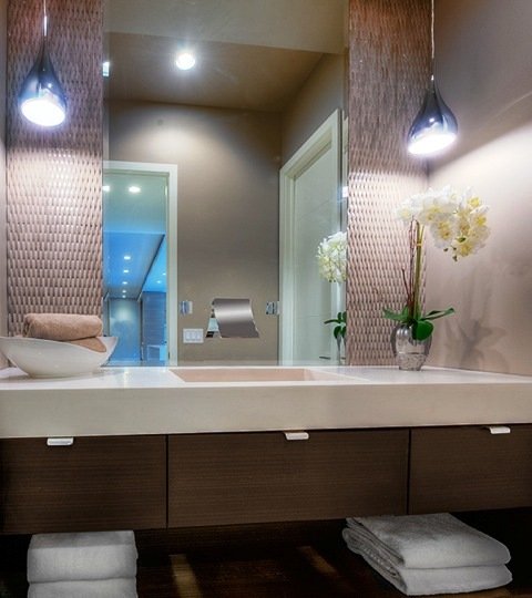 Floating vanity with sink and mirror with two pendant lights above