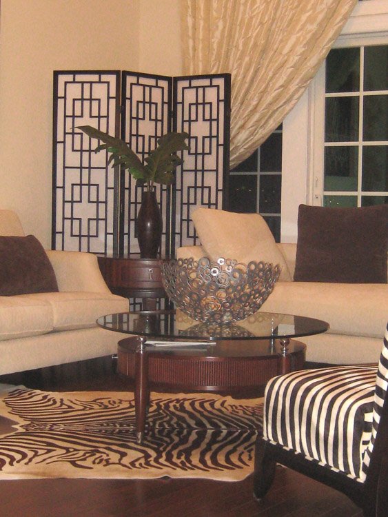 Sitting area with white couches and zebra patterned chair