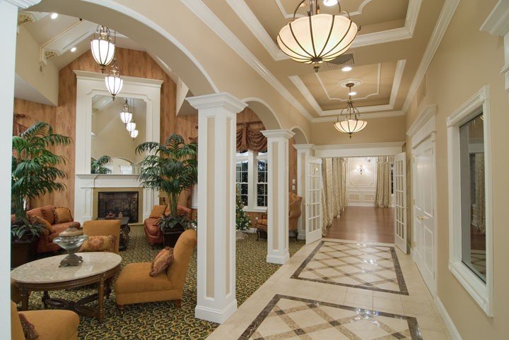 Hallway with intricate stone patterned flooring and a sitting area off to the left side